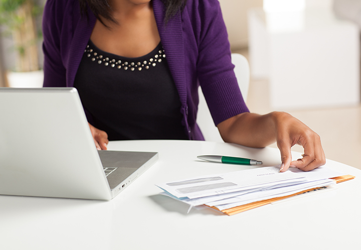 Person sitting at a desk in front of a laptop